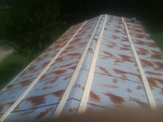 Rusted metal roof panels with new wood purlins before replacement — Storm Damage Roof Repair in Luray by Roofing Brothers